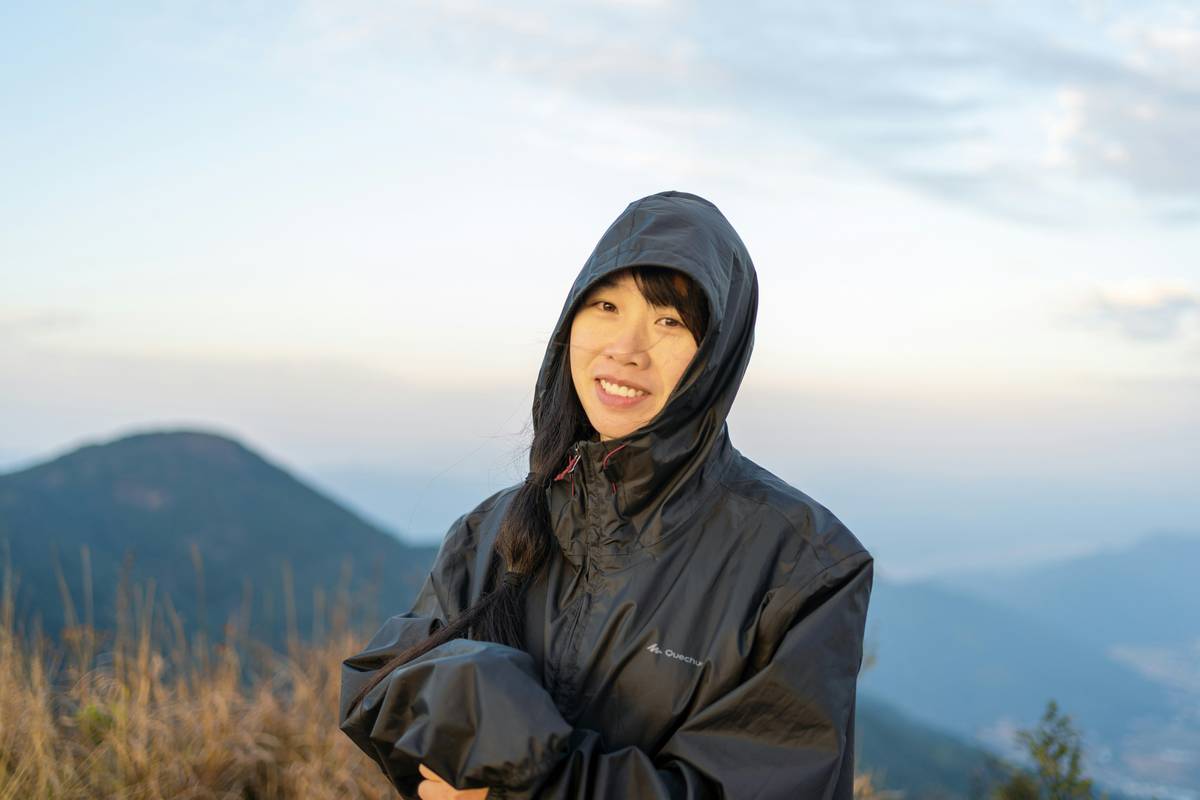 Side-by-side comparison of bulky vs. ultralight rain jackets compressed into stuff sacks—left shows large pouch, right fits in palm